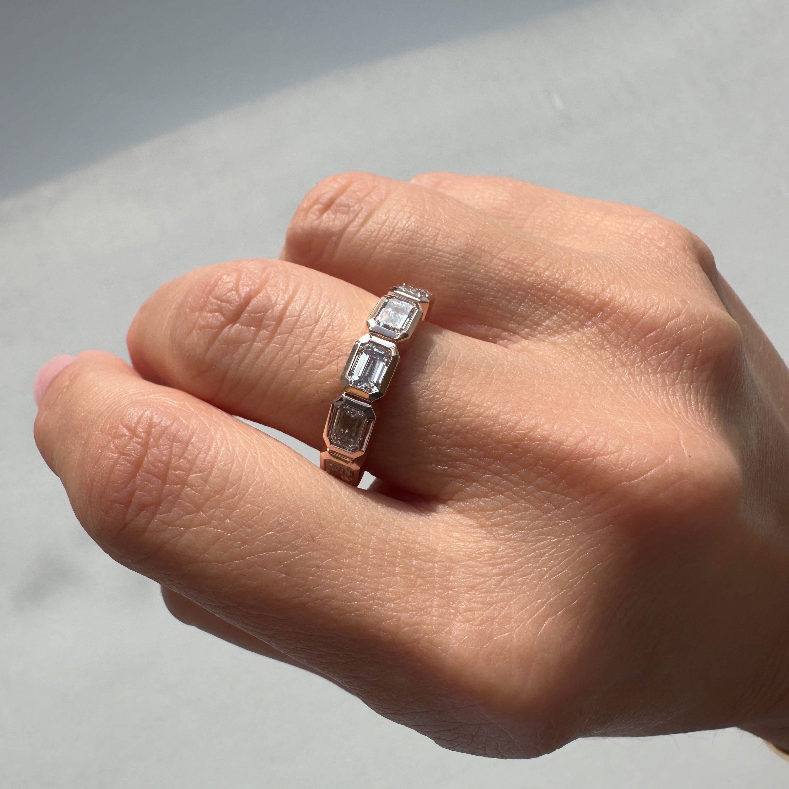 Five East-West Emerald Bezel Ring